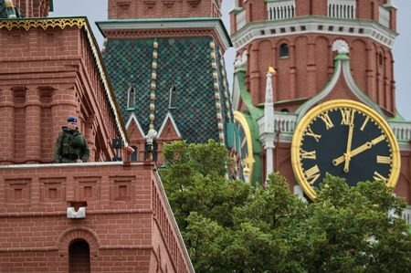FILE PHOTO: A security guard watches from the Kremlin's tower