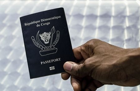 FILE PHOTO: An immigration official displays a Congolese biometric passport