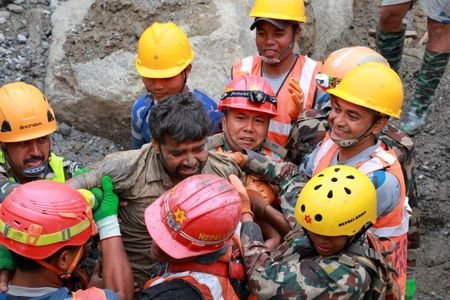 Survivor Sanjay Sah carried by members of a search and