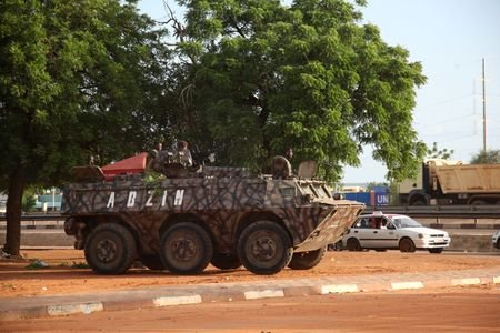 Military armoured vehicles take position on the street following a