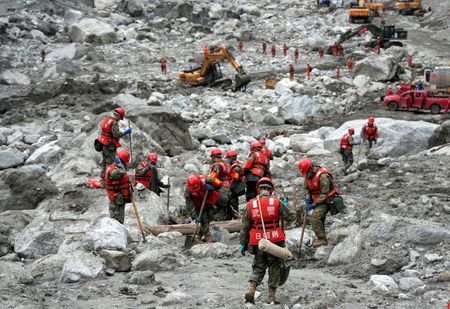 Rescue workers conduct search and rescue operations following mudslide at