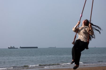 Vessels in the Strait of Hormuz near the beach of
