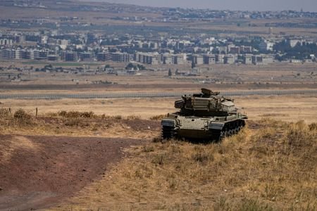 An Israeli tank stands in position near the ceasefire line