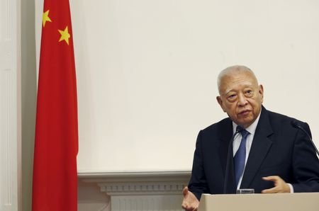 FILE PHOTO: Former Hong Kong Chief Executive Tung Chee-hwa holds