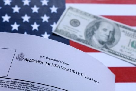U.S. flag, mock passport, 100 dollar banknote and H-1B visa
