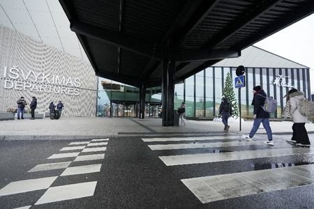 Passengers walk to the departure terminal at Vilnius Ciurlionis International