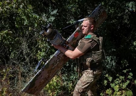 Ukrainian servicemen prepare to launch a strike drone towards Russian