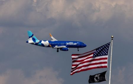 FILE PHOTO: A JetBlue Airlines commercial aircraft flies over Washington