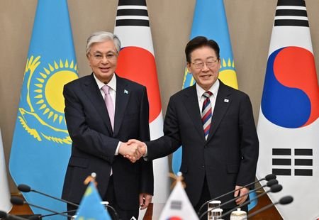 Kazakhstan's President Kassym-Jomart Tokayev shakes hands with South Korea's President
