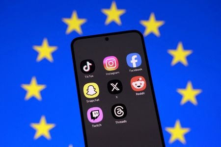 FILE PHOTO: Illustration shows an EU flag and smartphone with
