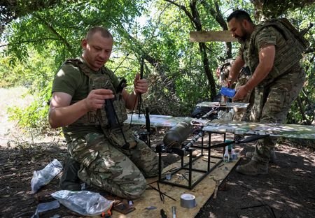 Ukrainian servicemen prepare to launch a strike drone towards Russian