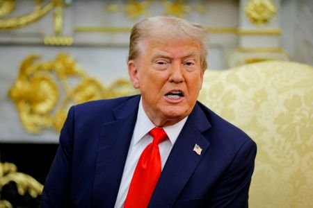 FILE PHOTO: U.S. President Donald Trump reacts as he and