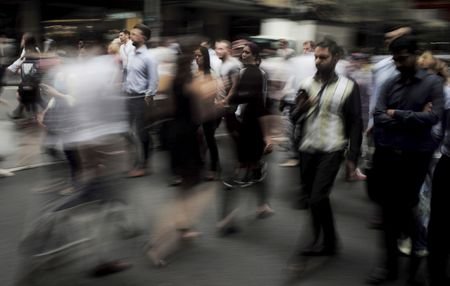Pedestrians walk through Sydney's business district