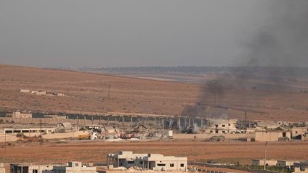Smoke rises from a weapons depot following an explosion in