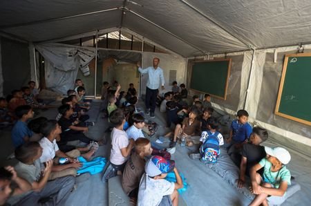 Palestinian students attend their first day of the new school