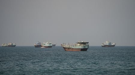 FILE PHOTO: Vessels trickle through Strait of Hormuz as Mideast