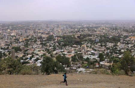 FILE PHOTO: A man runs in front of the cityscape