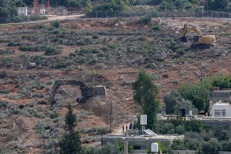Israeli military machinery uproots olive trees near Deir Nizam near