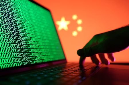 FILE PHOTO: A hand is seen on a laptop with