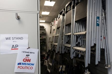Signs hang in the media work area at the White