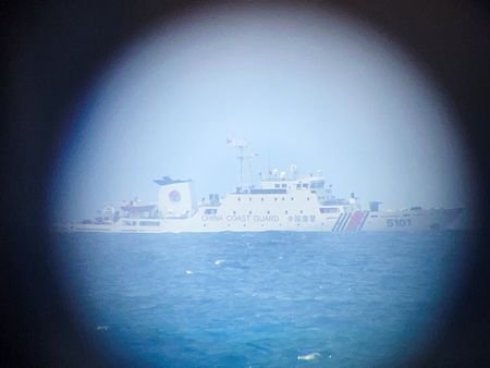 A China Coast Guard ship on the horizon through a