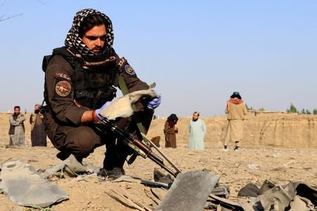 FILE PHOTO: A member of the Taliban security forces inspects