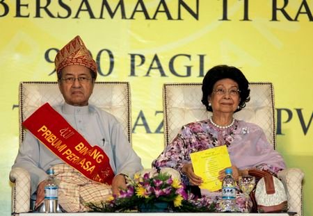 Malaysia's former prime minister Mohamad sits with his wife Siti