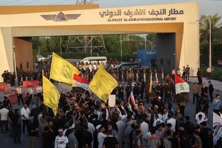Protesters gather outside Najaf International Airport during a demonstration against