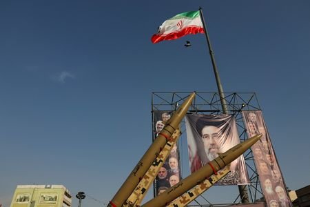 Iranian missiles are displayed next to a banner with a