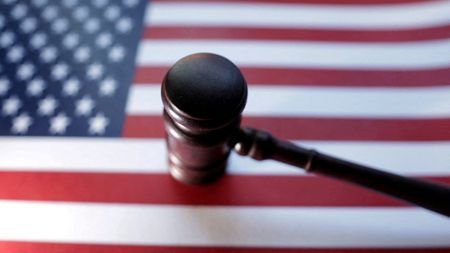 illustration shows U.S. flag and Judge gavel