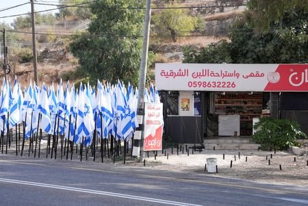 Israeli settlers installed flagpoles outside Palestinian shop in West Bank