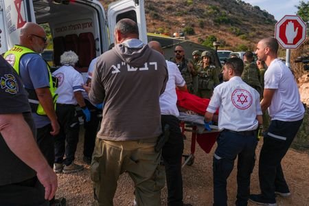 Israeli paramedics place a person on a stretcher in an
