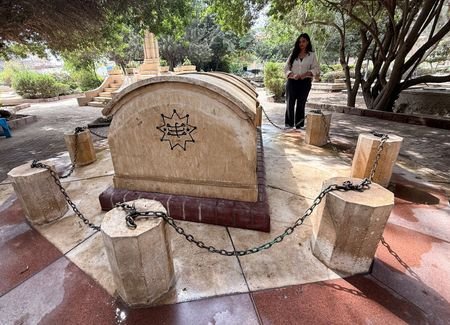 Egyptian Baha'i architect Joumana Labib enters a cemetery dedicated to