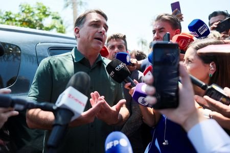 Brazilian presidential candidate Flavio Bolsonaro speaks to the media after
