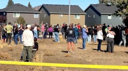 People react at the scene of a shooting at Silver
