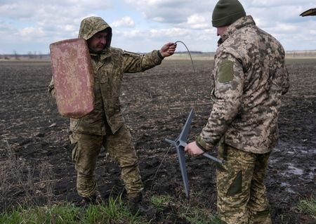 FILE PHOTO: Ukrainian servicemen set up Starlink satellite internet system