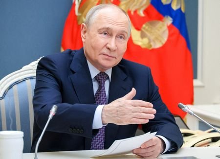 FILE PHOTO: Russian President Vladimir Putin meets with members of