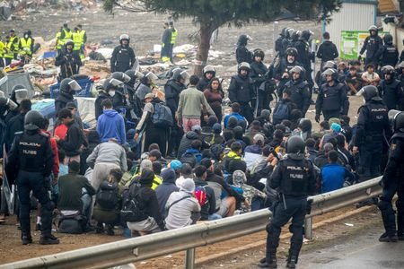 Spanish police clear an encampment of migrants at El Trampolin