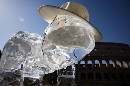 Greenpeace activists place ice statues near the Colosseum in Rome