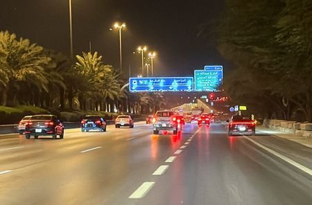 Vehicles drive along a street near the Diplomatic Quarter in