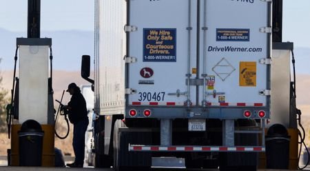 Driver fills semi with diesel at truck stop in Dunnigan,