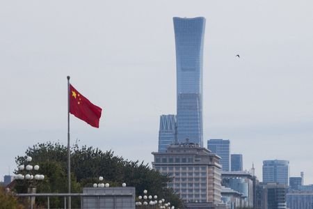 Chinese national flag flies past skyscrapers of the Central Business