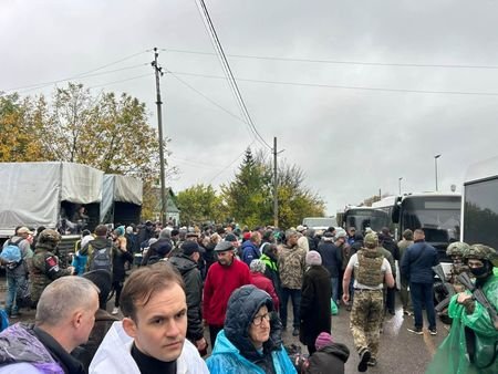 People attend an evacuation from the Russian-occupied city of Oleshky